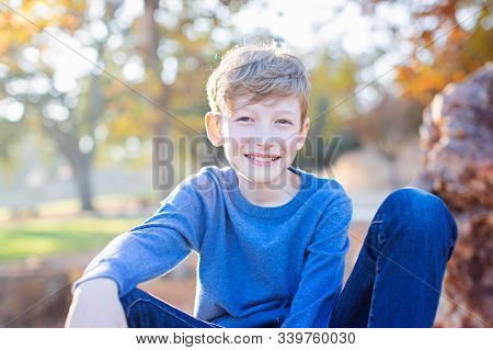 Cute Smiling Boy Spending Time Outdoors At Fall