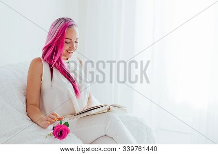 The Girl With The Pink Hair Is Reading A Book In A White Room