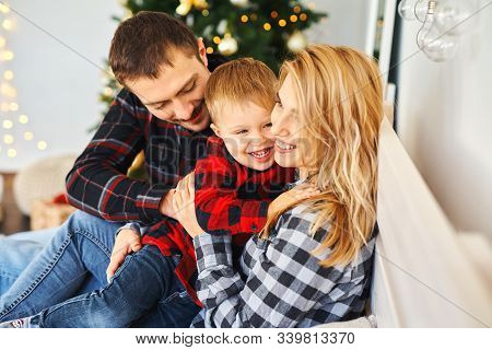 Happy Family Mother, Father, Child Sonspending Time Together In Bed At Home.
