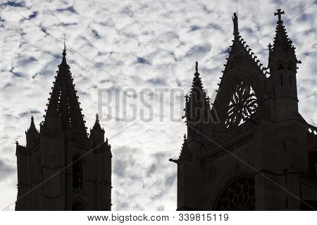 Leon Cathedral Southern Tower And Saint Froilan Top. Silhouette Over Cloudy Sky