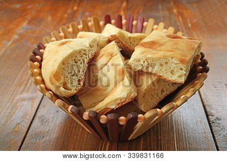 Many Pieces Of Cut Georgian Bread In A Basket On Wooden Table