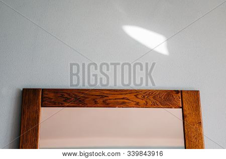Close Up Of Mirrow In The Bedroom On The Blue Wall. Minimalism Of Interior Of The Room