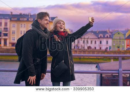 Happy Tourists Taking Photo Of Themselves. Holidays, Travel, Vacation, Tourism And Dating Concept. W