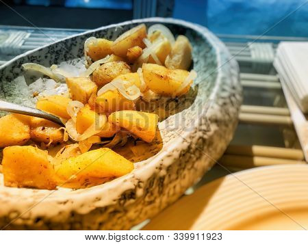 Restaurant On The Pier. Fried Potatoes With Onions On A Platter.