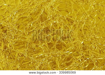Gold Foil Leaf Shiny Texture, Abstract Yellow Wrapping Paper For Background And Design Art Work.