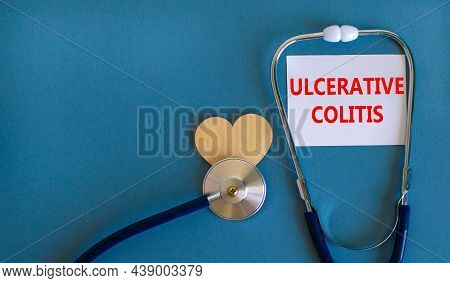 Ulcerative Colitis Symbol. White Card With Words Ulcerative Colitis, Beautiful Blue Background, Wood
