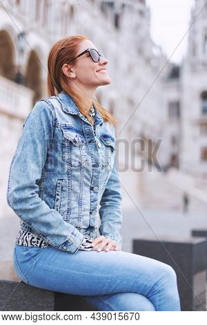 Young Redhead Woman In Sun Glasses At Parliament Building, Budapest, Hungary