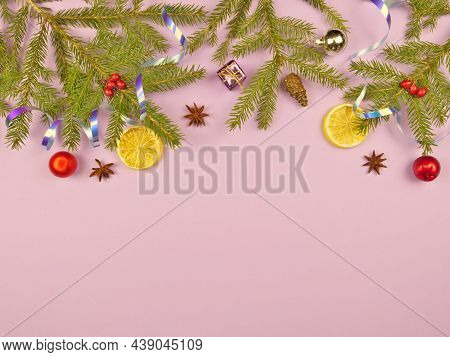 Christmas Background. Branches Of A Christmas Tree And Christmas Tree Toys On A Pink Background. New