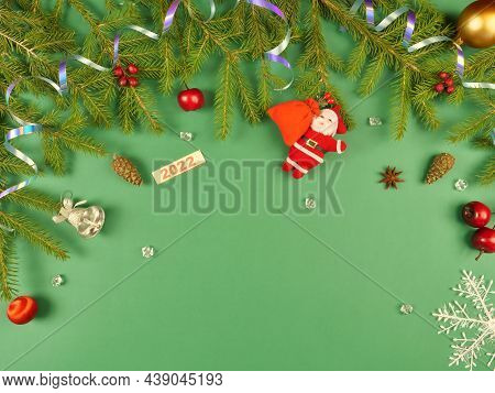 Christmas Background. Branches Of A Christmas Tree And Christmas Tree Toys On A Green Background. Ne