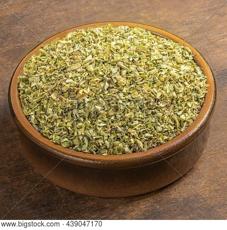 Dried Oregano Spice On A Wooden Background. Heap Of Oregano In A Clay Bowl.