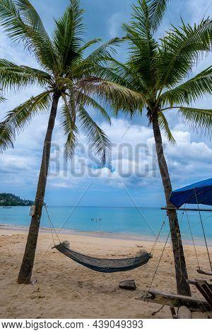 Kamala Beach On Phuket Island In Thailand. Hammock At The Beach Of Kamal In Phuket Thailand