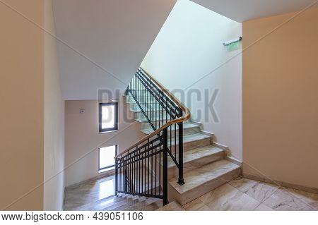 Modern Stair Case Between Floors. Stairs With Metallic Rail In Modern Building