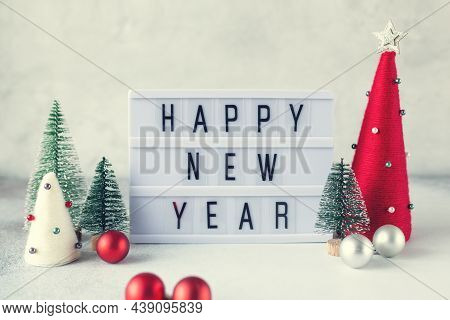 Lightbox With Text Happy New Year With Yarn Wrapped Xmas Cone Trees. New Year Celebration. Vintage T