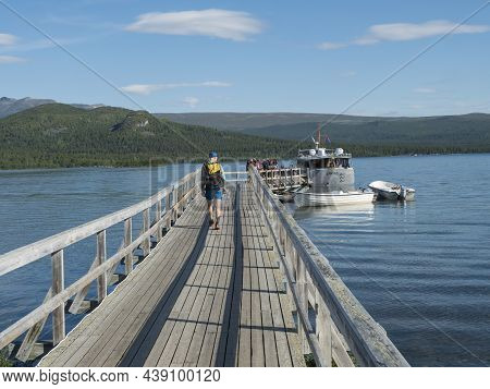 Saltoluokta, Norrbotten, Sweden, Agust 7, 2021: Group Of Hikers And Tourist Getting In Ferry Boat Sh