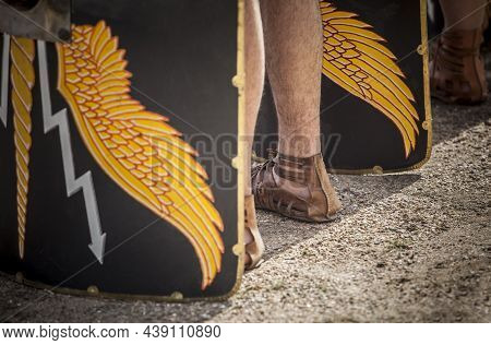 Roman Legionaries In Formation. Scuta Or Shields On Ground. Faint Eagle-wing And Thunderbolt Motifs 