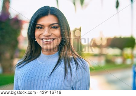 Beautiful hispanic woman smiling confient at the city