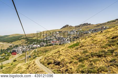 Sierra Nevada Village With Cable Car Going Up Into The Mountains, Spain
