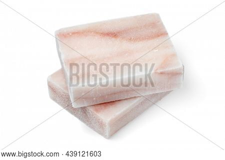 Pieces of frozen Pollock fish fillet as an ingredient for cooking close up on white background