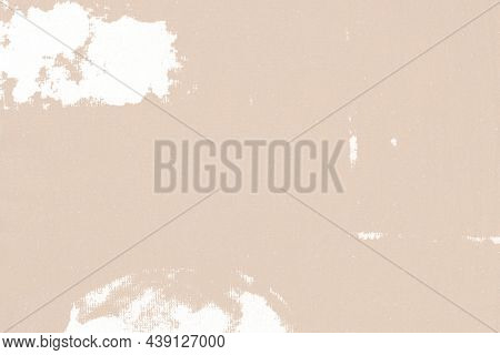 Beige textured background with white fabric stain