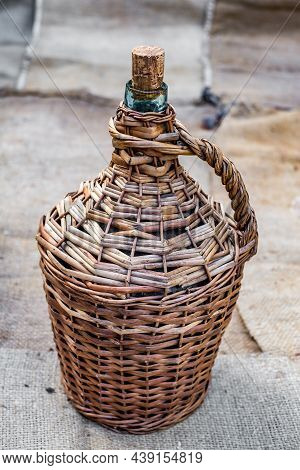 Demijohn And Old Wood Wine Barrel On Jute Sack