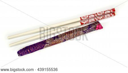 Wooden Chopsticks With Cloth Cover On White Background