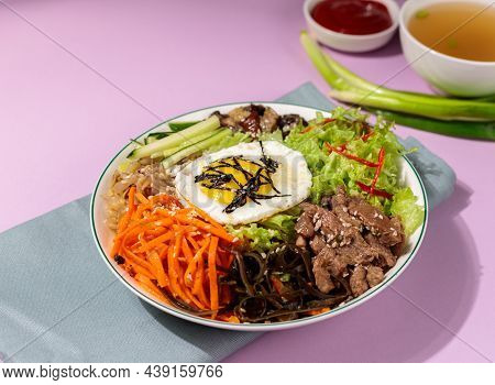 Bibimbap Or Pibimpap, One Of The Most Popular Dishes Of Korean Cuisine. Boiled Rice With Various Sal