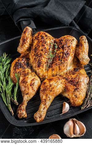 Bbq Spatchcocked Barbecue Whole Chicken On Grill Pan. Black Background. Top View