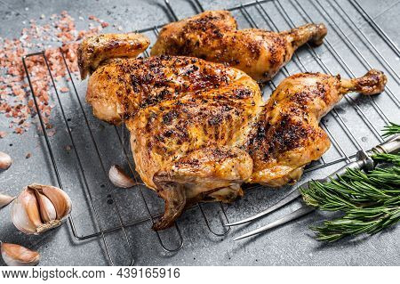 Traditional Spatchcocked Barbecue Chicken On Grill. Gray Background. Top View