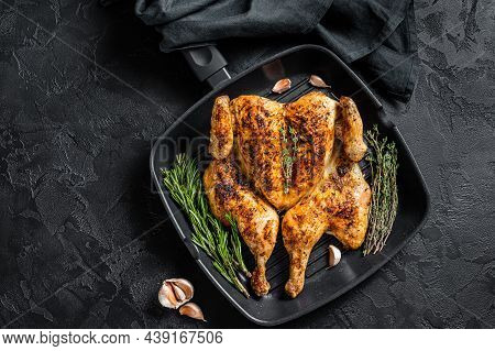 Bbq Spatchcocked Barbecue Whole Chicken On Grill Pan. Black Background. Top View