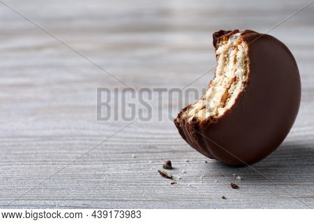 Tasty Bitten Choco Pie On White Wooden Table, Closeup. Space For Text