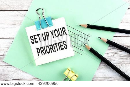 Text Set Up Your Priorities On The Short Note With Pencils On Wooden Background