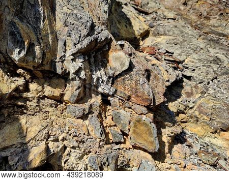 Geodesy. Stone Texture. The Rock Is Brown And Red. Mineral Background. Design From Natural Materials