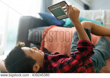 Asian boy using tablet for video call, with class on screen. communication technology and online education, digital composite image.