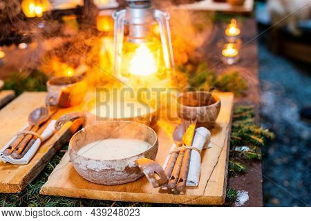 Bowl of delicious mushroom cream soup served in lappish hut next to open fire