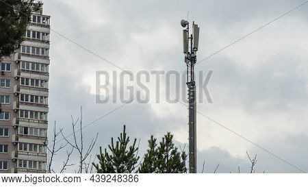 Tower With Mobile Operator Antennas On The Dramatic Sky Background. Tower Hosted Equipment Cellula. 