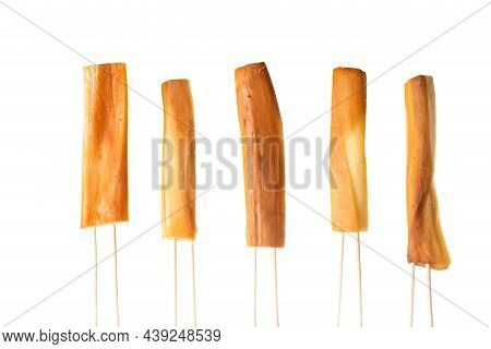 Cheese In The Form Of Cheese Sticks Strung On Wooden Sticks On A White Plate, Isolate. Beer Snack