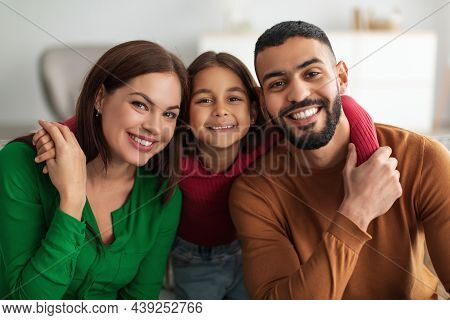 Portrait Of A Happy Arab Family Smiling At Home