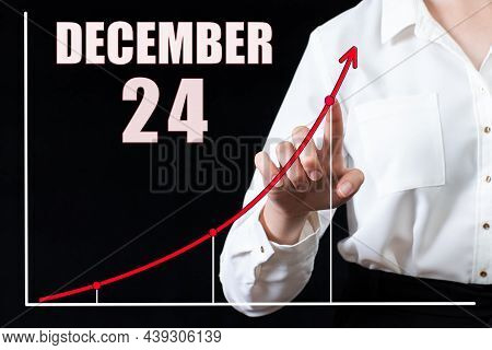 24th Day Of December. Businesswoman's Hand Pointing To The Graph And A Calendar With The Date Of 24 