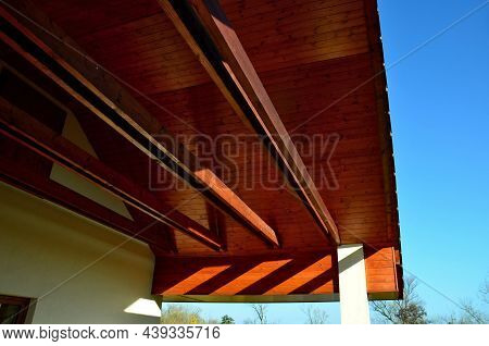 The Ceiling Of The Open Shed Of The Garage Lined With Wooden Planks. Wooden Siding Is Suitable For N