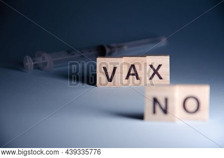 No Vax Concept. Anti-vaccination From Coronavirus. Inscription No Vax Stands On Blurred Syringe Back