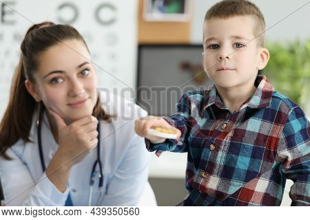 Little Boy Holding Yellow Gelatin Capsules At Doctor Appointment. Taking Vitamin D And Preventing Ri