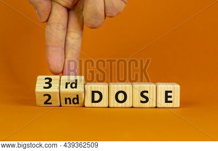 Covid-19 Booster Dose Vaccine Shot Symbol. Doctor Turns Cubes And Changes Words '2nd Dose' To '3rd D