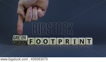 Green Or Carbon Footprint Symbol. Businessman Turns Wooden Cubes And Changes Words 'carbon Footprint
