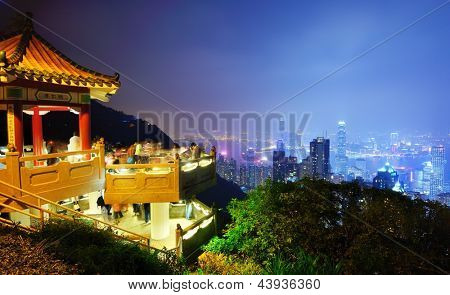 HONG KONG - OCTOBER 13: Tourists at Lion Pavilion on the Peak October 13, 2012 in Hong Kong, PRC. With over 7 million tourists annually, the peak is one of the city's most visited attraction.