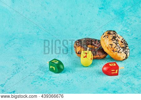 Happy Hanukkah And Hanukkah Sameach - Traditional Jewish Donuts, Spinning Tops On Blue Background