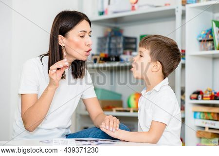 A Cute Boy With A Speech Therapist Is Taught To Pronounce The Letters, Words And Sounds.