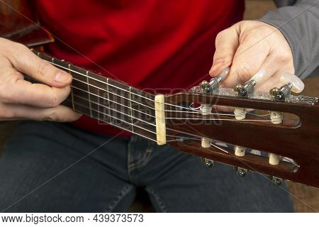 Replacing And Tuning Nylon Strings On A Six-string Classical Guitar. Instruction For Musician