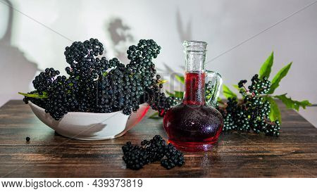 Ripe Elderberry Squeezed In Syrup In A Bottle. Natural Black Berry Juice. Homeopathy Copy Space.