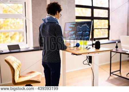 Adjustable Height Desk Stand In Office Using Computer