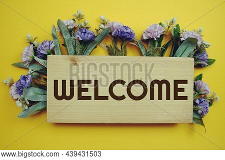 Welcome Sign With Flowers Frame Decprate On Yellow Background